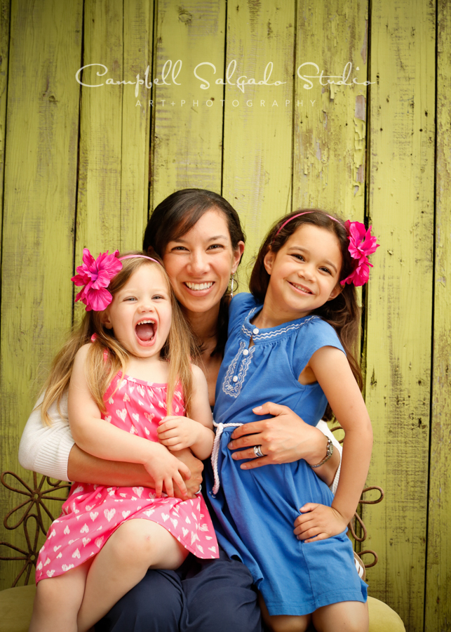  Portrait of mother and daughters on lime fence boards background&nbsp;by family photographers at Campbell Salgado Studio, Portland, Oregon. 