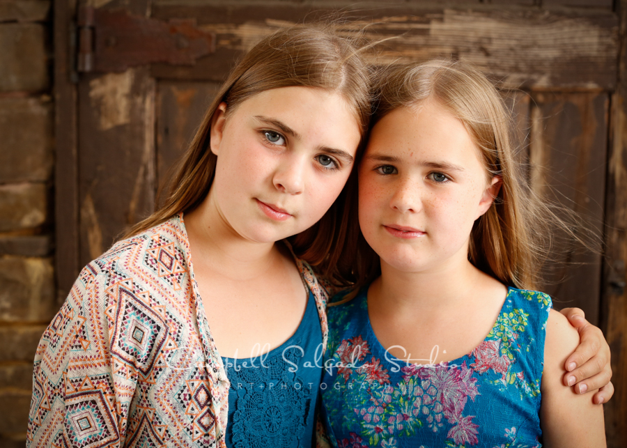  Portrait of sisters on rustic door background&nbsp;by child&nbsp;photographers at Campbell Salgado Studio, Portland, Oregon. 