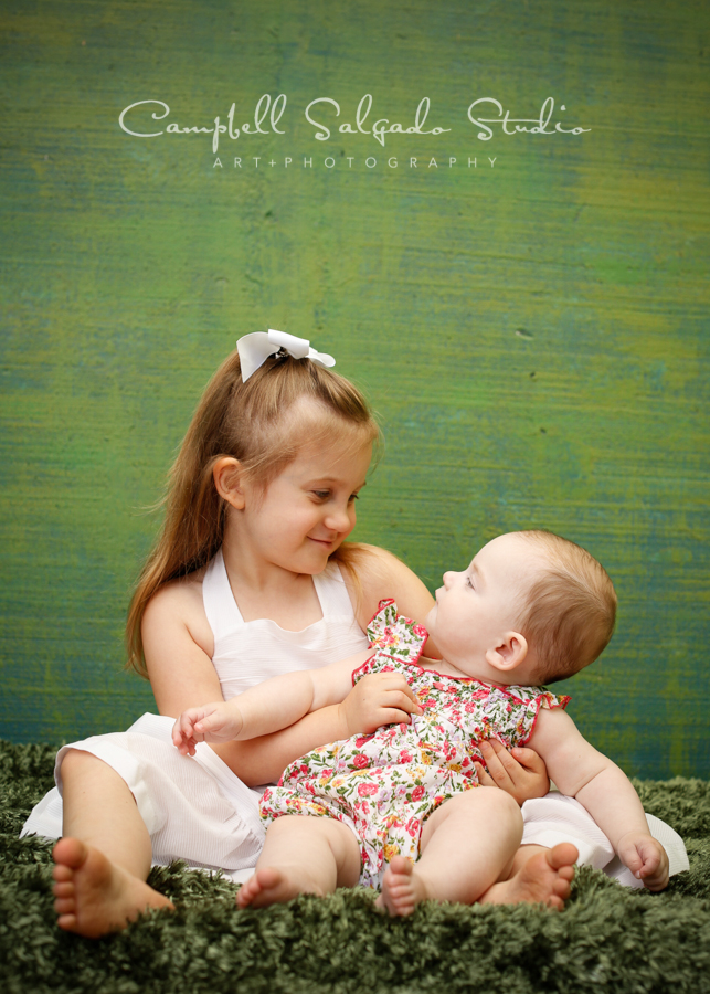  Portrait of sisters on green weave background&nbsp;by childrens photographers at Campbell Salgado Studio, Portland, Oregon. 