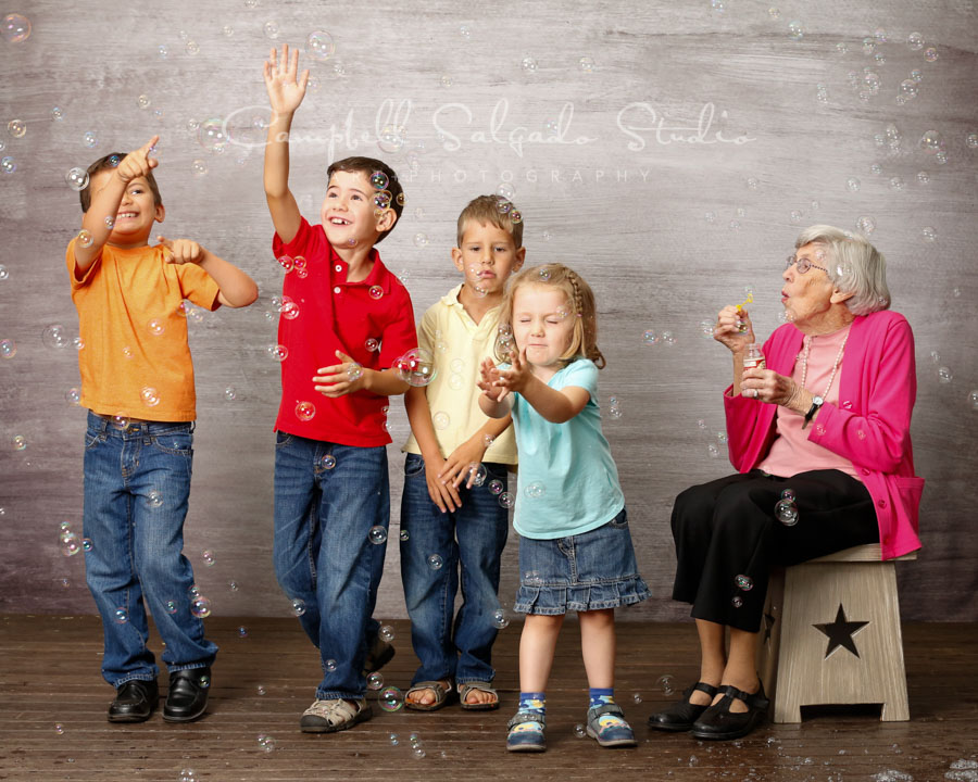  Portrait of great grandmother and great grandchildren on graphite background by family photographers at Campbell Salgado Studio in Portland, Oregon. 