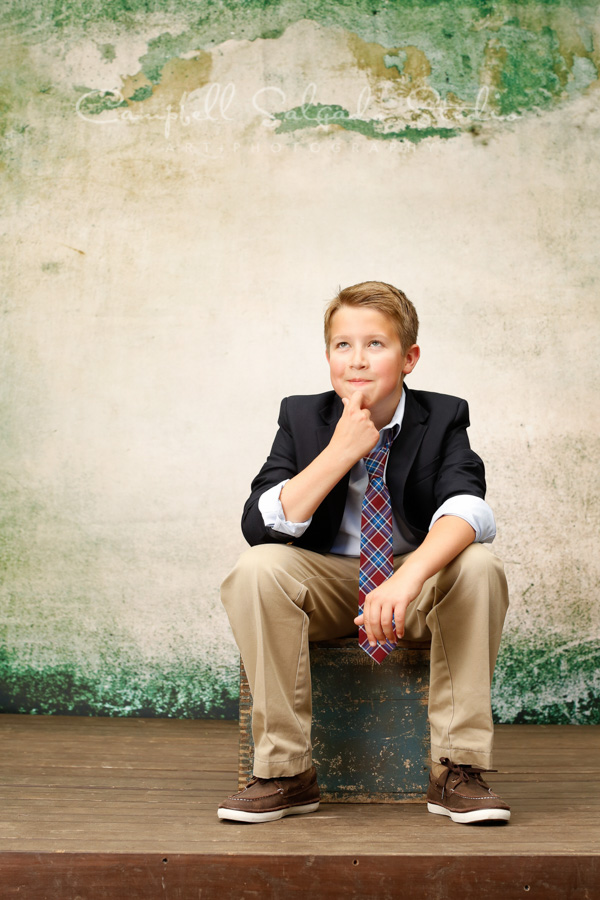  Portrait of boy on abandoned concrete background by child photographers at Campbell Salgado Studio in Portland, Oregon. 