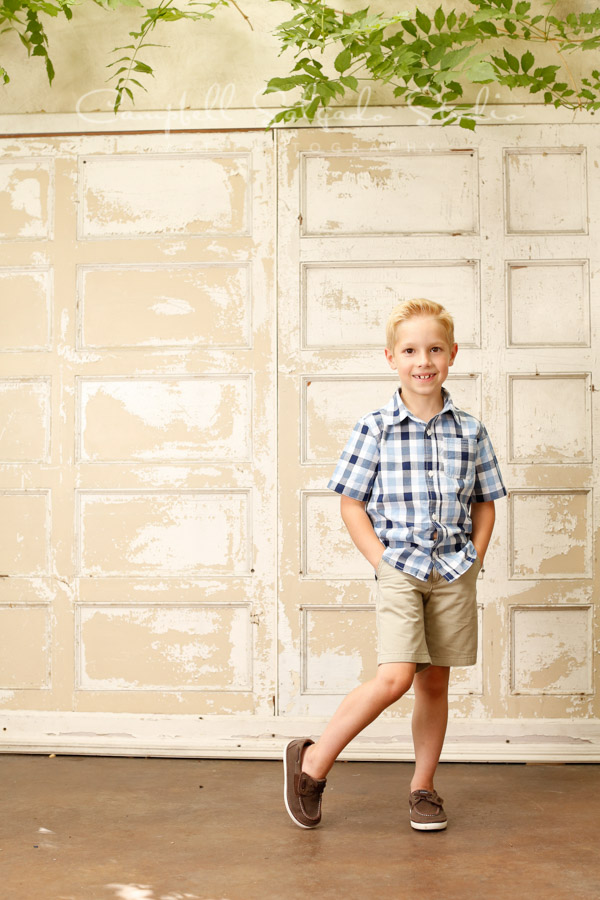  Portrait of boy on antique white doors&nbsp;background by child photographers at Campbell Salgado Studio in Portland, Oregon. 