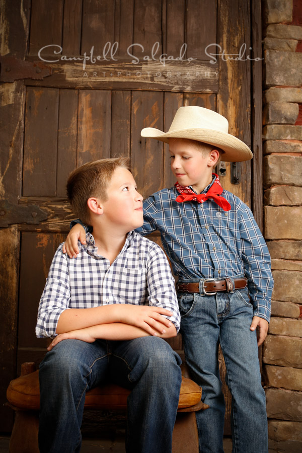  Portrait of brothers on rustic door background by child photographers at Campbell Salgado Studio in Portland, Oregon. 