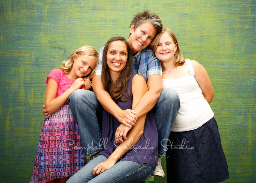  Portrait of family on blue green weave&nbsp;background by family photographers at Campbell Salgado Studio in Portland, Oregon. 