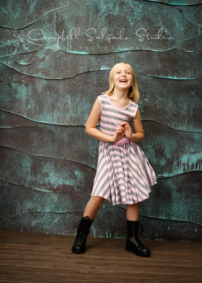  Portrait of girl on copper wave background by children's photographers at Campbell Salgado Studio in Portland, Oregon. 