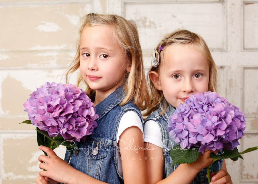  Portrait of twins on antique ivory doors by childrens photographers at Campbell Salgado Studio in Portland, Oregon. 