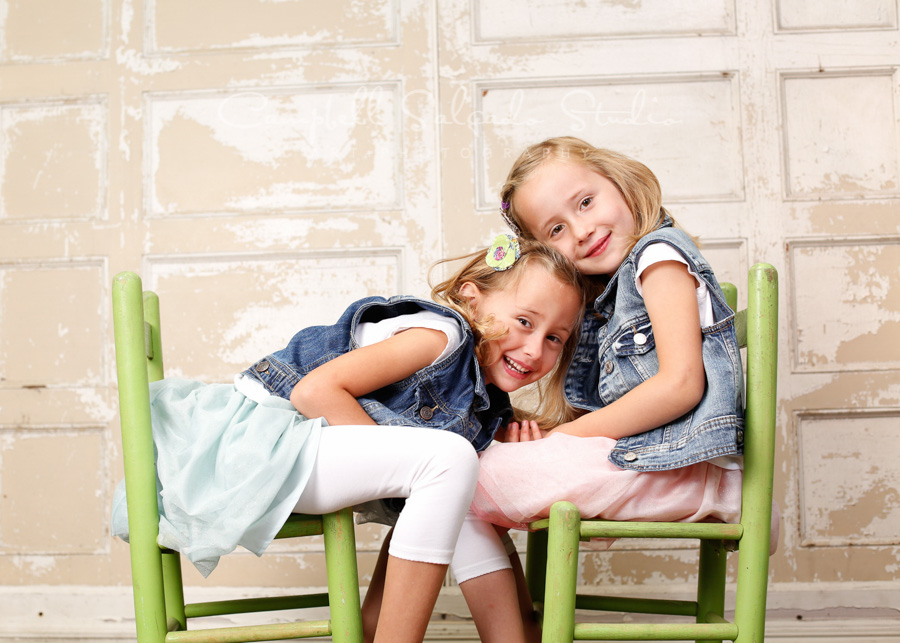  Portrait of twins on antique ivory doors by childrens photographers at Campbell Salgado Studio in Portland, Oregon. 