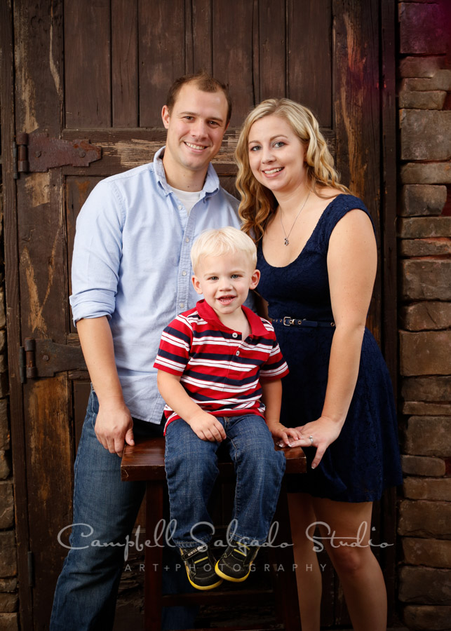  Portrait of family on rustic door background by family photographers at Campbell Salgado Studio in Portland, Oregon. 