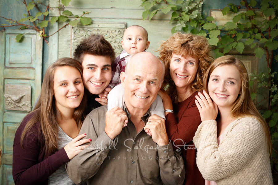  Portrait of multi-generational family on vintage green doors background by family photographers at Campbell Salgado Studio in Portland, Oregon. 