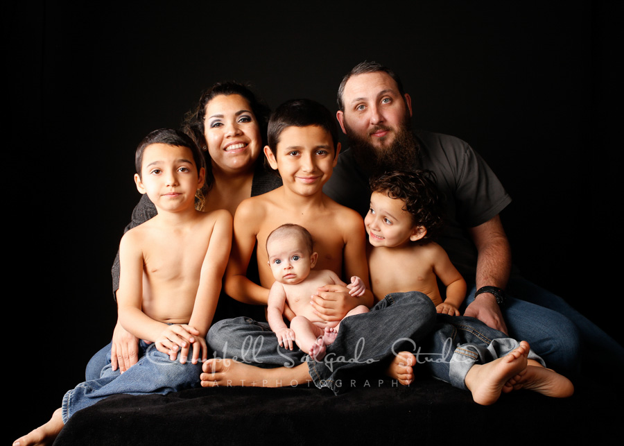  Portrait of family on black background by family photographers at Campbell Salgado Studio in Portland, Oregon. 