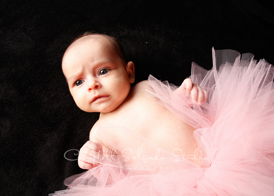  Portrait of baby on black background by children's photographers at Campbell Salgado Studio in Portland, Oregon. 