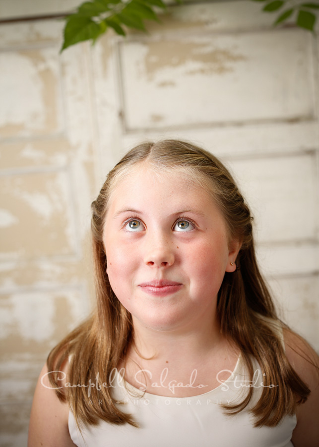  Portrait of girl on antique ivory doors background by childrens photographers at Campbell Salgado Studio in Portland, Oregon. 