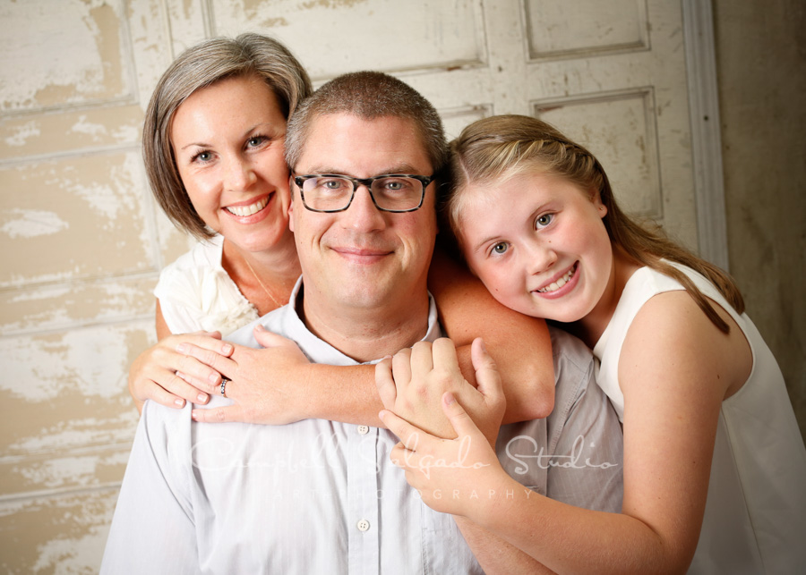  Portrait of family on antique ivory doors background by family photographers at Campbell Salgado Studio in Portland, Oregon. 