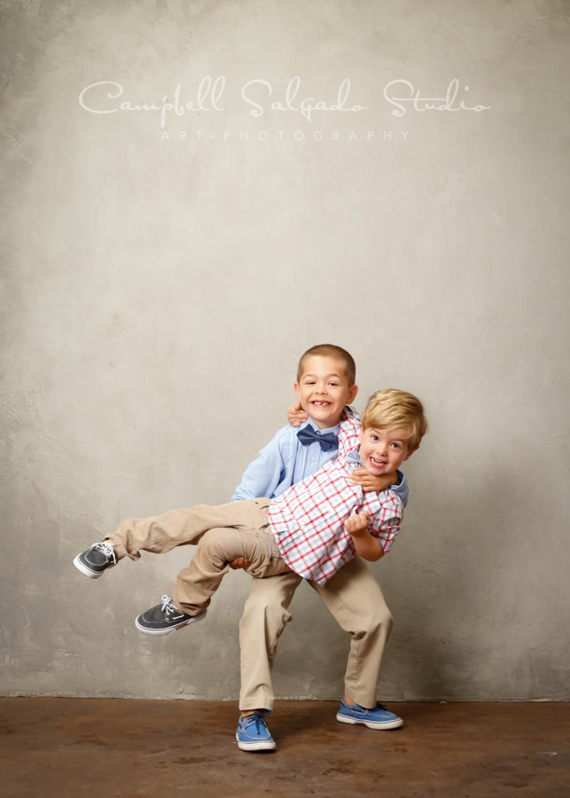  Portrait of brothers on modern gray background by child photographers at Campbell Salgado Studio in Portland, Oregon. 