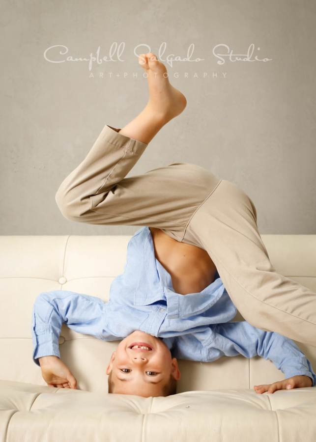  Portrait of boy on modern gray background by child photographers at Campbell Salgado Studio in Portland, Oregon. 