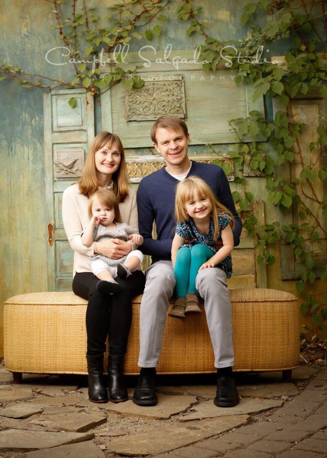  Portrait of family on vintage doors background by family photographers at Campbell Salgado Studio in Portland, Oregon. 