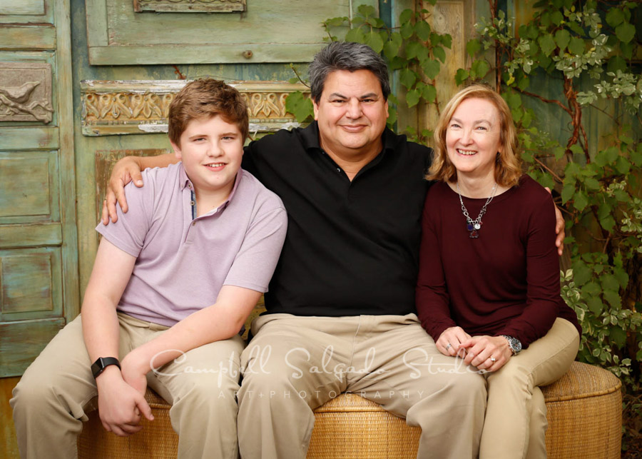  Portrait of family on vintage green doors background by family photographers at Campbell Salgado Studio in Portland, Oregon. 