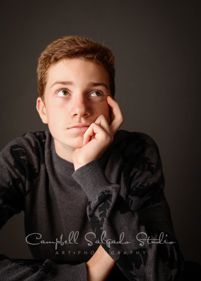 Portrait of teen on black background by teen photographers at Campbell Salgado Studio in Portland, Oregon.