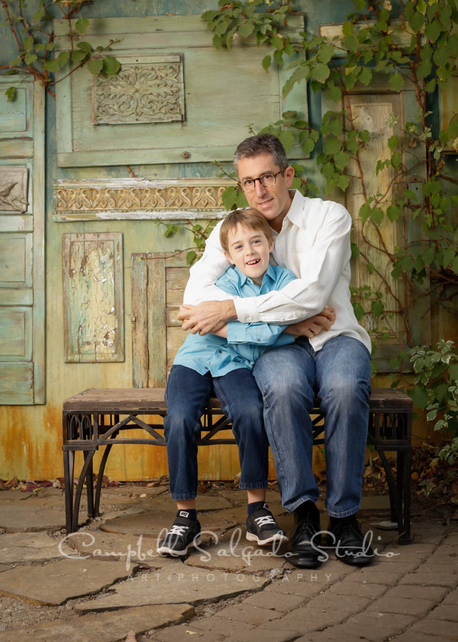  Portrait of father and son on vintage green doors background by family photographers at Campbell Salgado Studio in Portland, Oregon. 