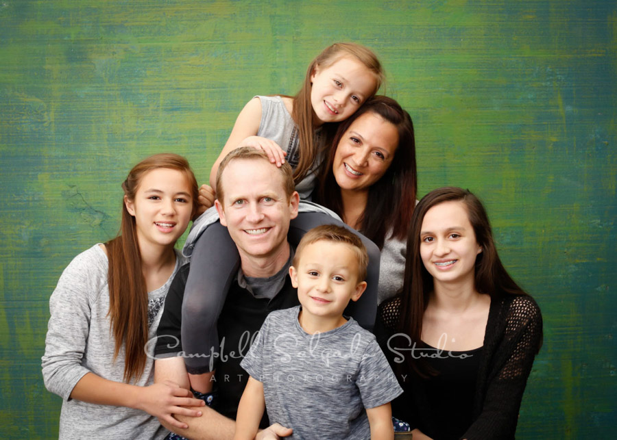  Portrait of family on blue-green weave background by family photographers at Campbell Salgado Studio in Portland, Oregon. 