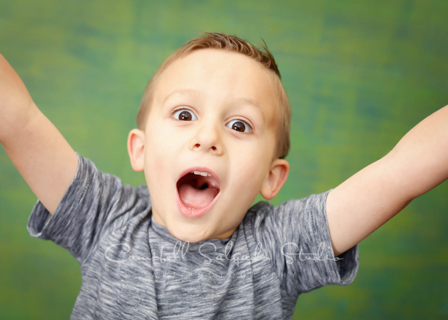  Portrait of child on blue-green weave background by child photographers at Campbell Salgado Studio in Portland, Oregon. 