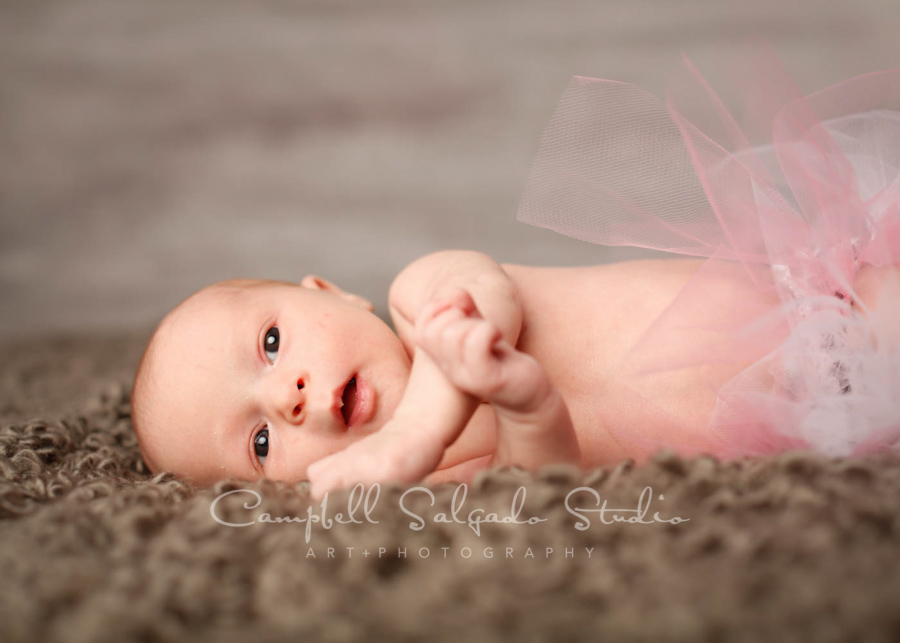  Portrait of infant on graphite background by newborn photographers at Campbell Salgado Studio in Portland, Oregon. 