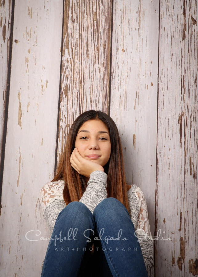  Portrait of girl on white fenceboards background by teen photographers at Campbell Salgado Studio in Portland, Oregon. 