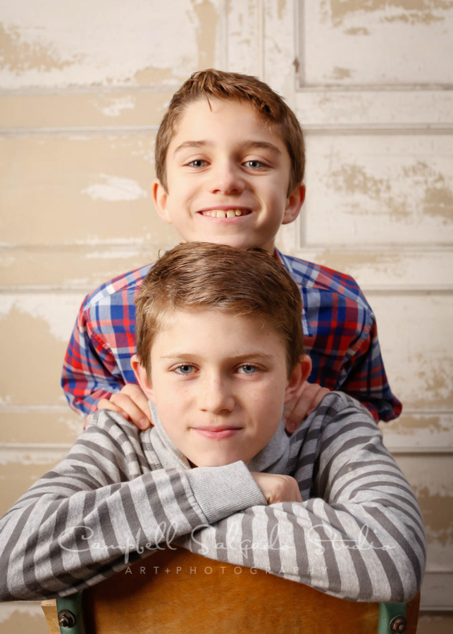  Portrait of boys on antique ivory doors background by child photographers at Campbell Salgado Studio in Portland, Oregon. 