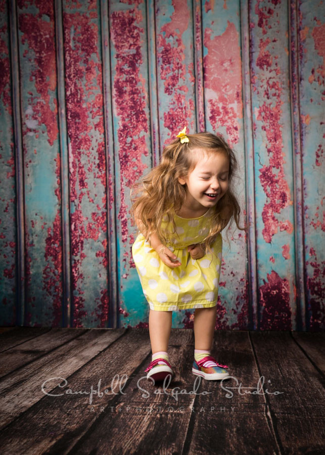  Portrait of little girl on Italian rust background by child photographers at Campbell Salgado Studio in Portland, Oregon. 