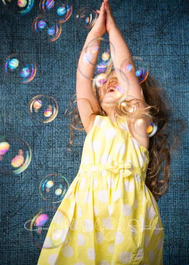  Portrait of little girl on denim background by child photographers at Campbell Salgado Studio in Portland, Oregon. 