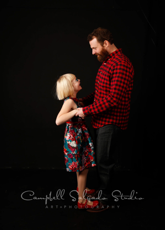   Portrait of dad and daughter on black  background &nbsp;by  family &nbsp;photographers at Campbell Salgado Studio in  Portland , Oregon.  