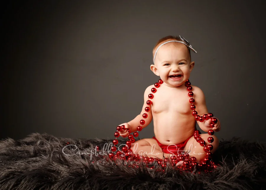Portrait of child on gray background by child photographers at Campbell Salgado Studio in Portland , Oregon.