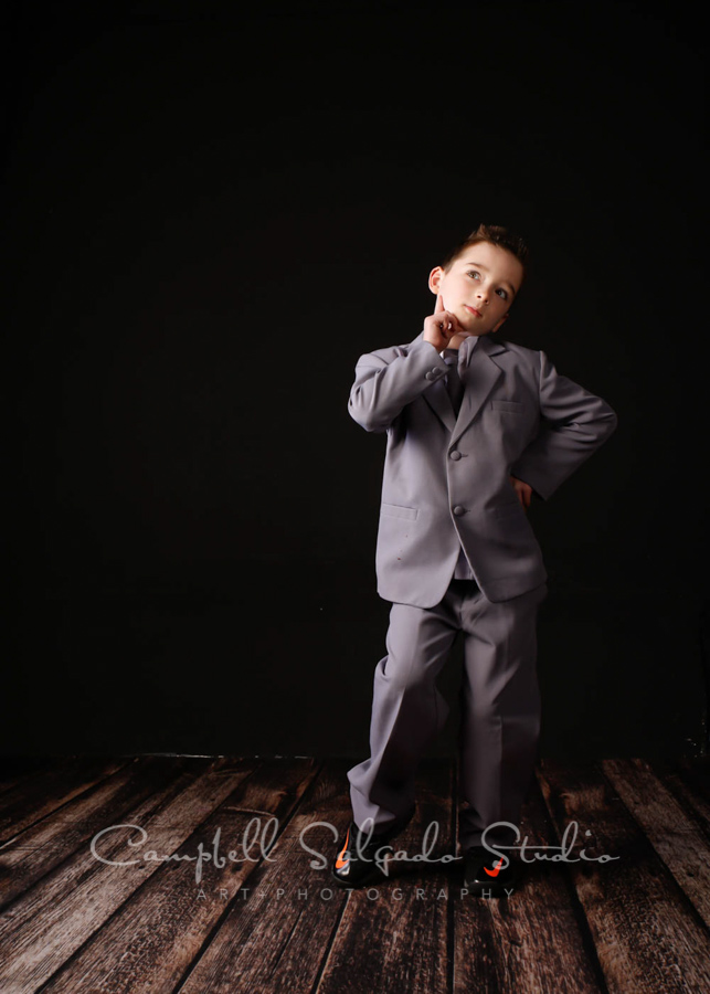  Portrait of child on black background by child photographers at Campbell Salgado Studio in Portland, Oregon. 