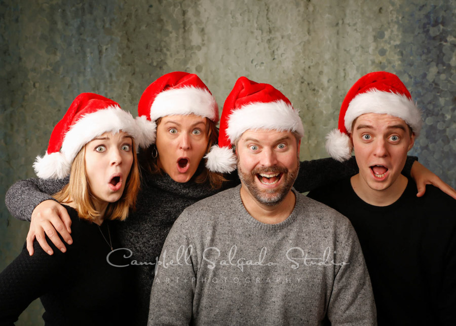  Holiday portrait of family on rain dance background by family portrait photographers at Campbell Salgado Studio in Portland, Oregon. 