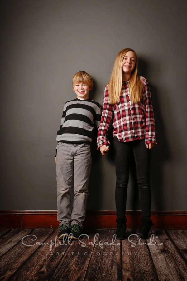 Portrait of kids on grey background by children's photographers at Campbell Salgado Studio in Portland, Oregon.