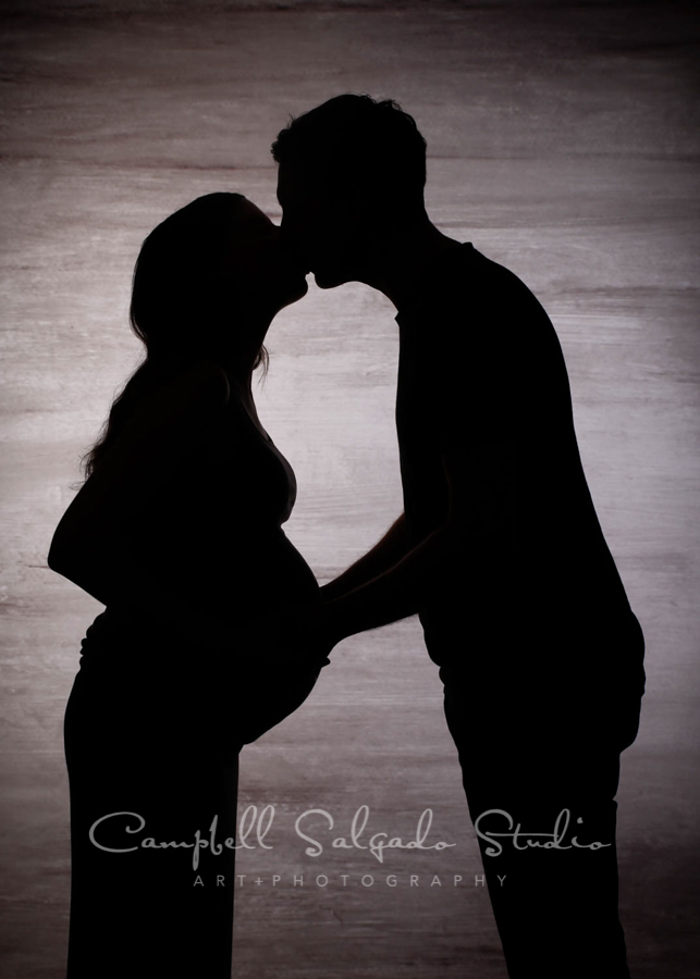  Silhouette portrait of couple on graphite background by maternity photographers at Campbell Salgado Studio in Portland, Oregon. 