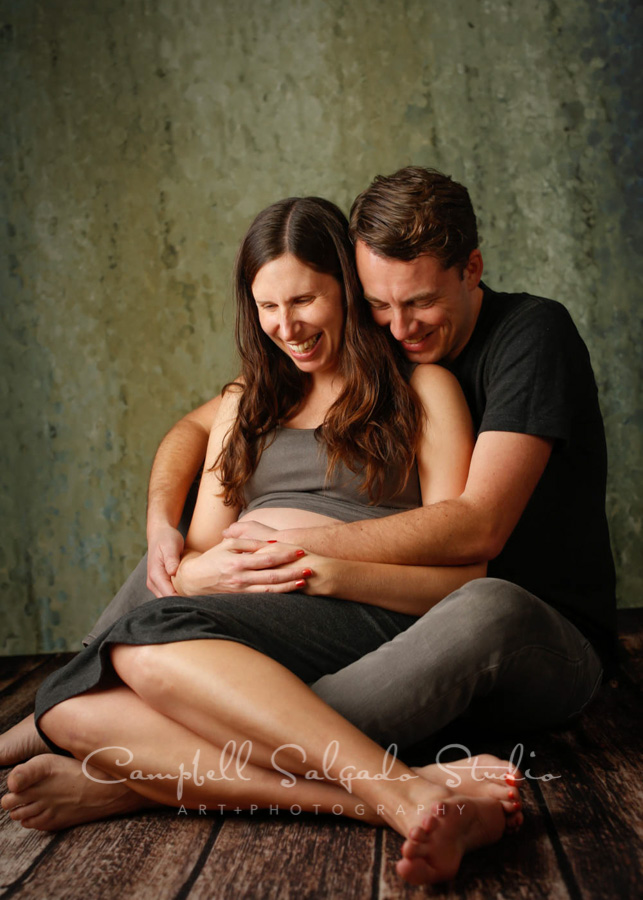  Maternity portrait of couple on rain dance background by maternity photographers at Campbell Salgado Studio in Portland, Oregon. 