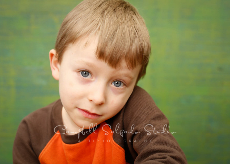  Portrait of boy on blue green weave background by children's photographers at Campbell Salgado Studio in Portland, Oregon. 