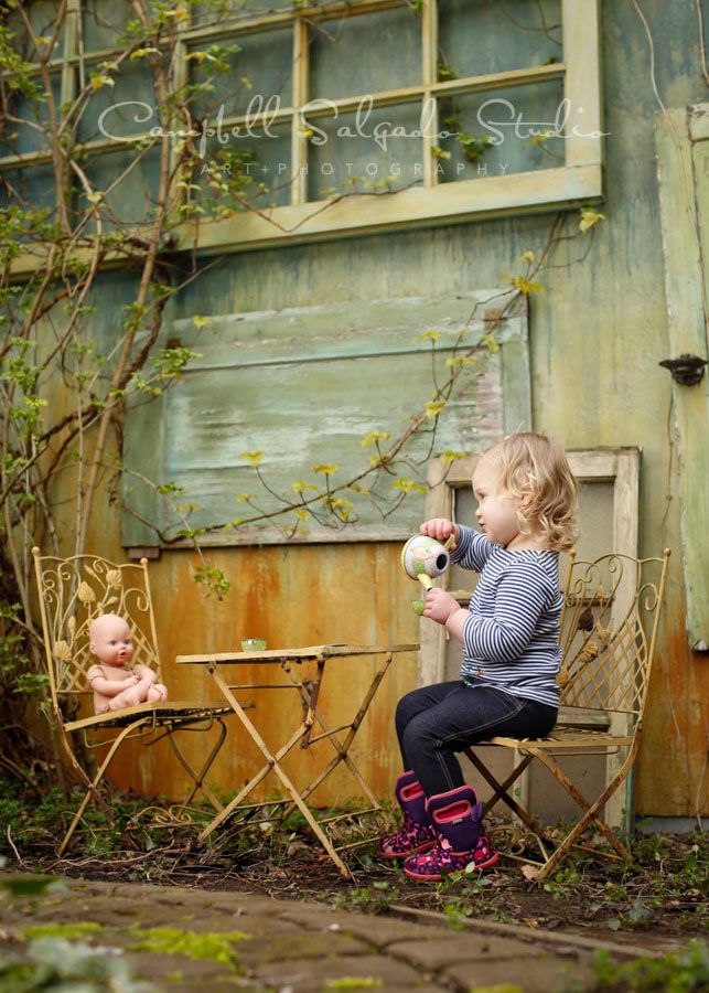  Portrait of toddler on vintage green doors background by child photographers at Campbell Salgado Studio in Portland, Oregon. 