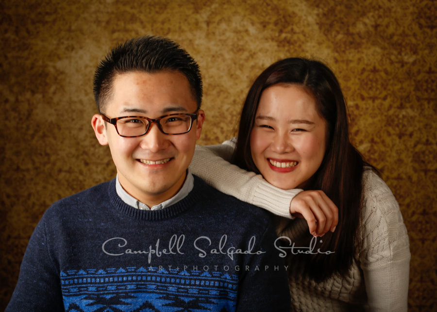  Portrait of couple on amber light background by couple's photographers at Campbell Salgado Studio in Portland, Oregon. 