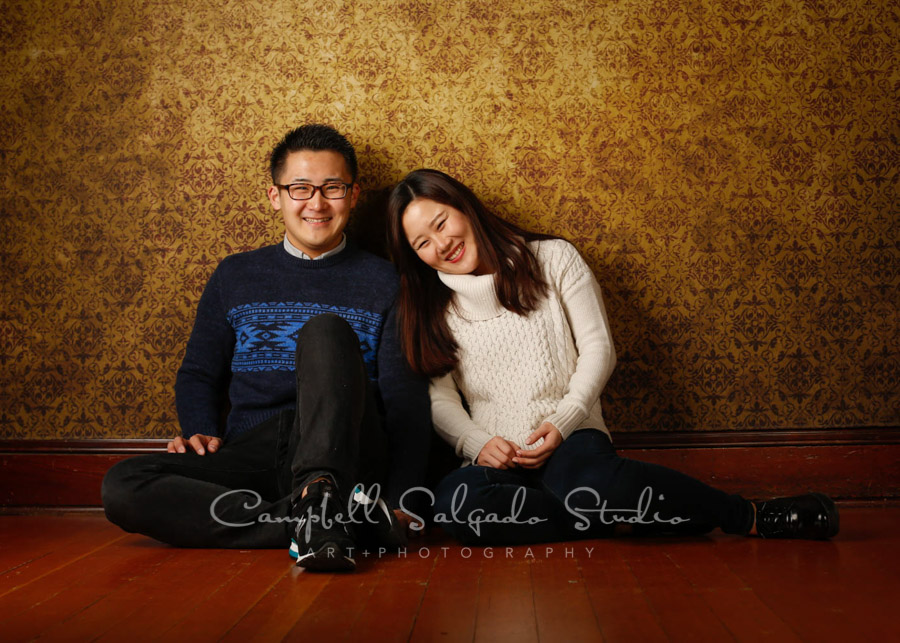  Portrait of couple on amber light background by couple's photographers at Campbell Salgado Studio in Portland, Oregon. 