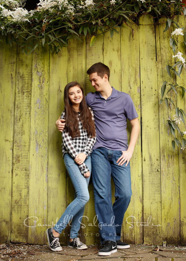  Portrait of teens on lime fenceboards background by family photographers at Campbell Salgado Studio in Portland, Oregon. 