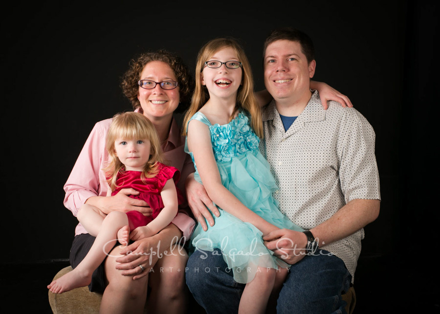  Portrait of family on black background by family photographers at Campbell Salgado Studio in Portland, Oregon. 