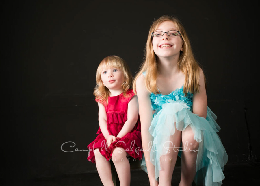  Portrait of sisters on black background by family photographers at Campbell Salgado Studio in Portland, Oregon. 