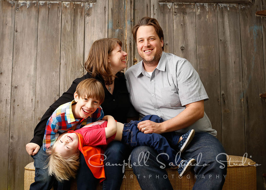  Portrait of family on barn doors background by family photographers at Campbell Salgado Studio in Portland, Oregon. 