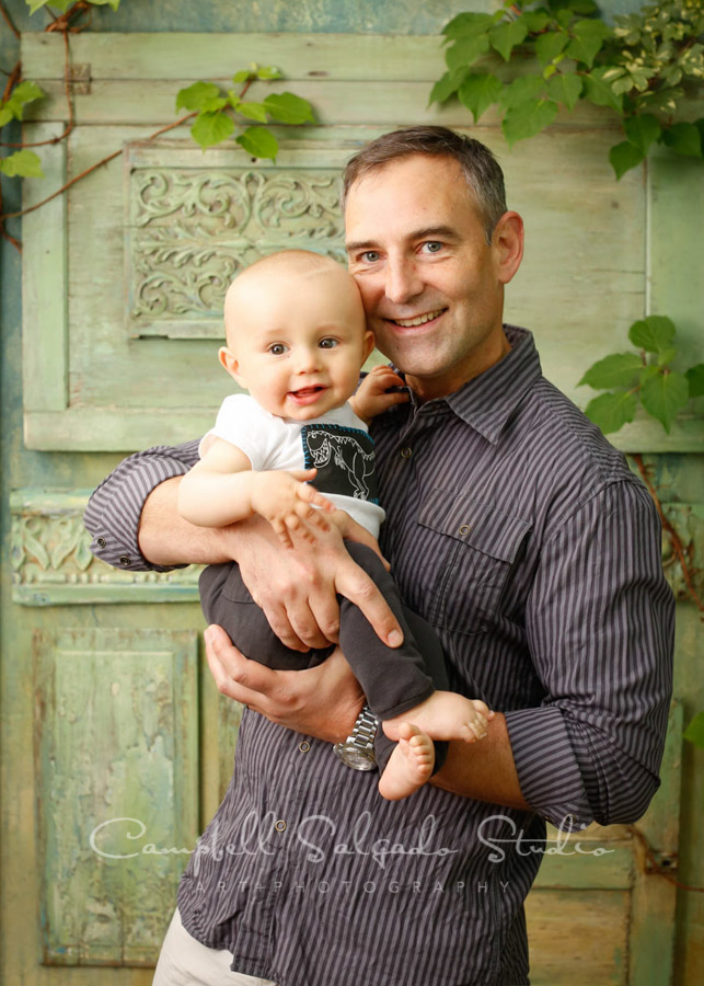  Portrait of father and son on vintage green doors background by family photographers at Campbell Salgado Studio. 