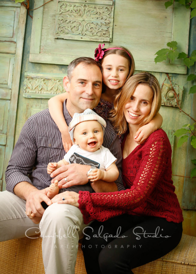  Portrait of family on vintage green doors background by family photographers at Campbell Salgado Studio. 