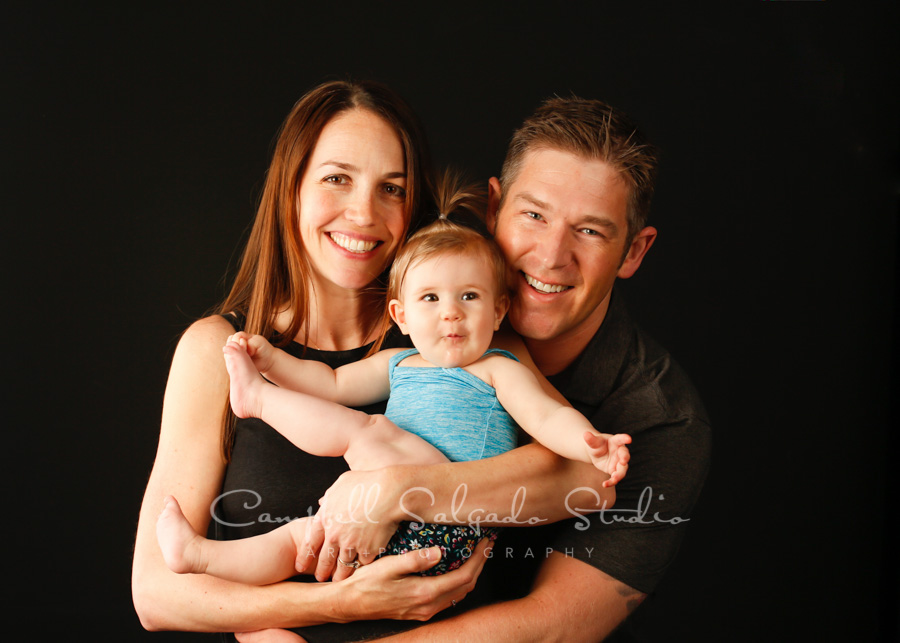  Portrait of family on black background by family photographers at Campbell Salgado Studio in Portland, Oregon. 