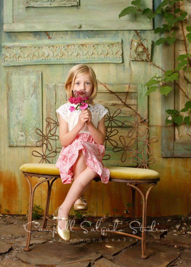  Portrait of girl on vintage green doors background by child photographers at Campbell Salgado Studio in Portland, Oregon. 