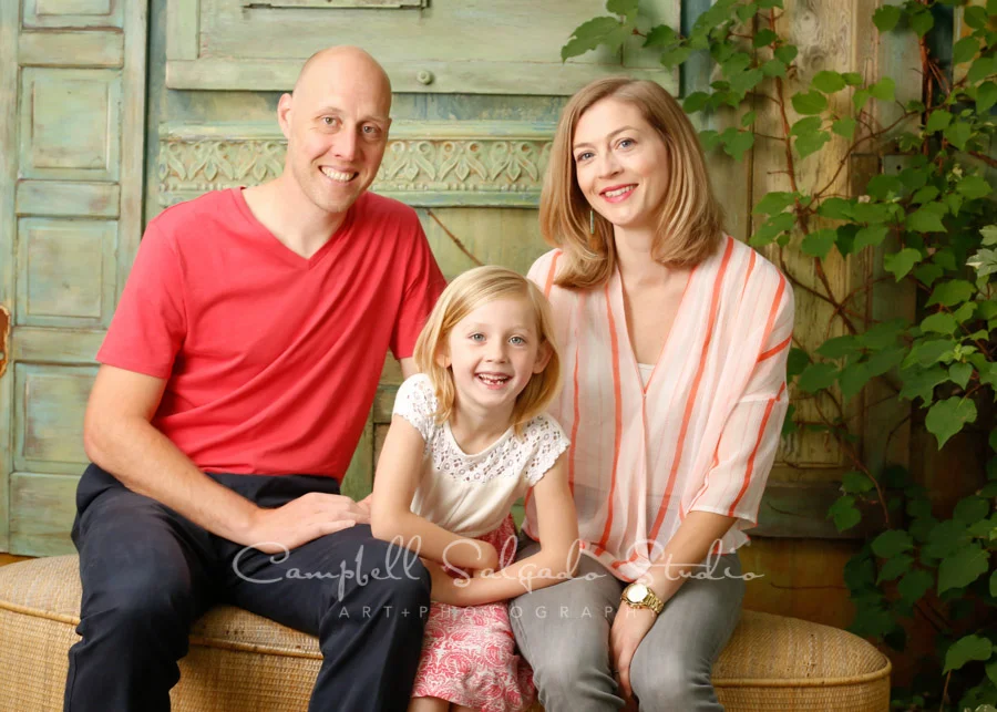 Portrait of family on vintage green doors background by family photographers at Campbell Salgado Studio in Portland, Oregon.